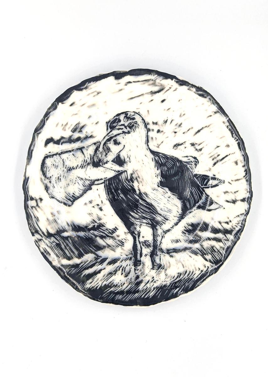 Hand built porcelain plate with black slip and sgraffito