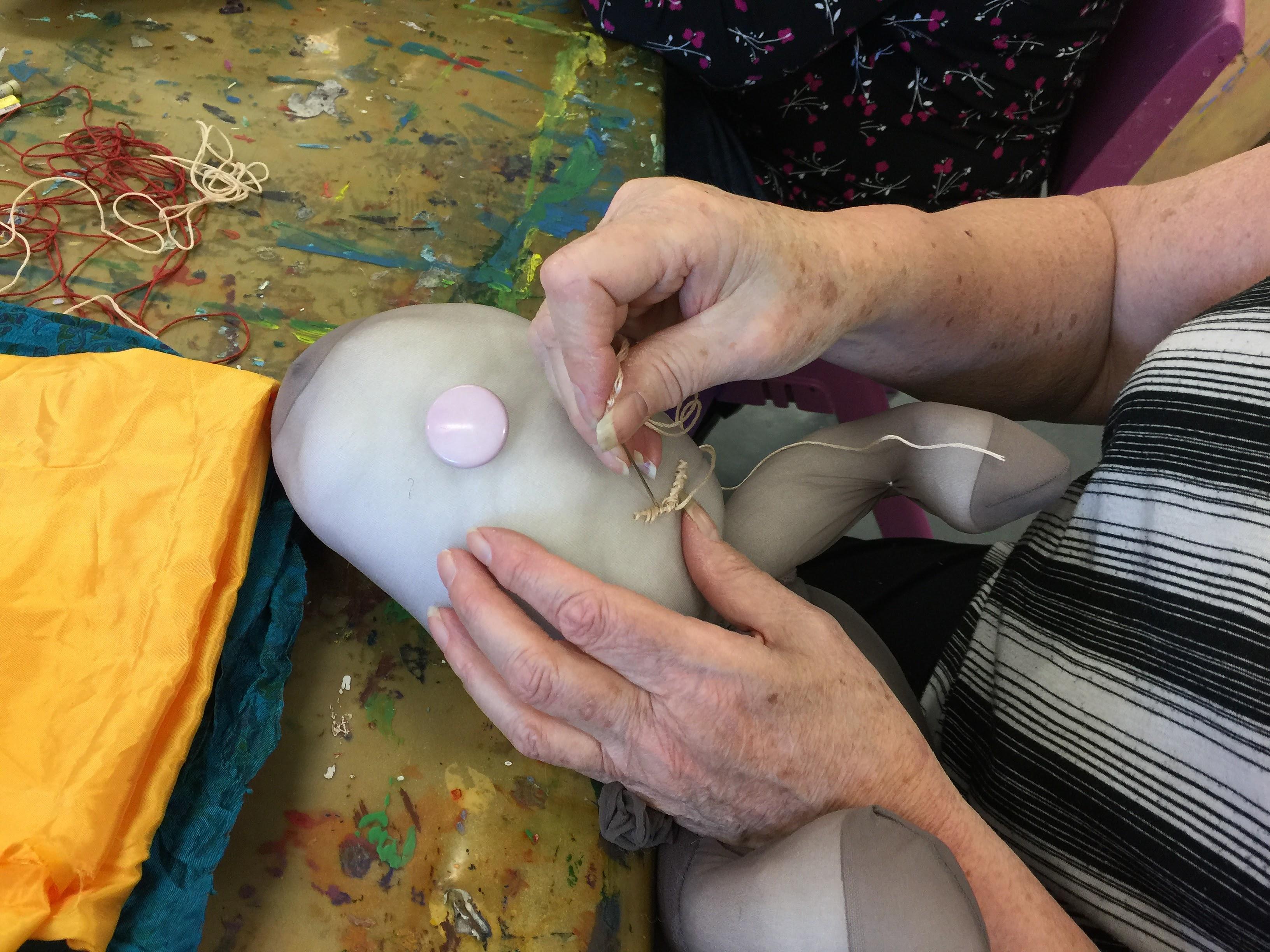 details of craft group working on soft sculptures.
