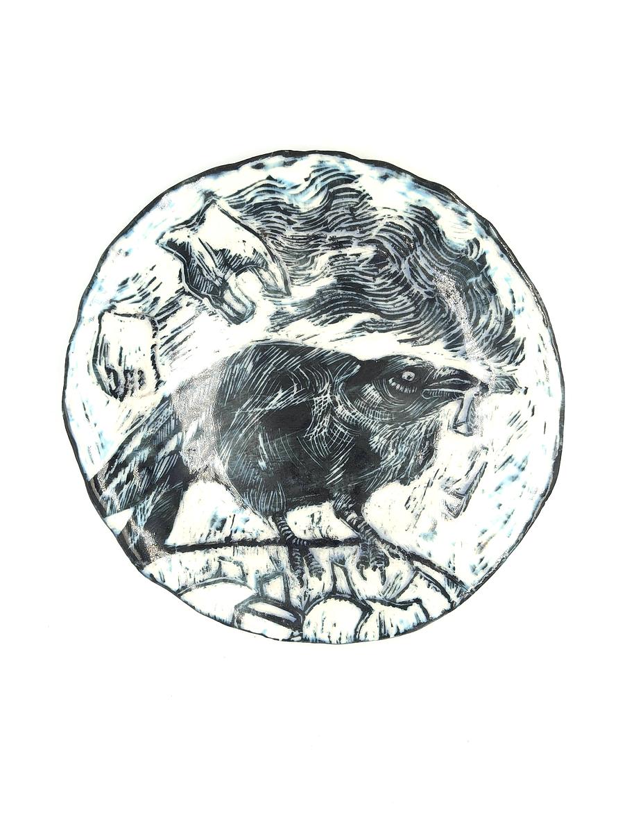 Hand built porcelain plate with black slip and sgraffito