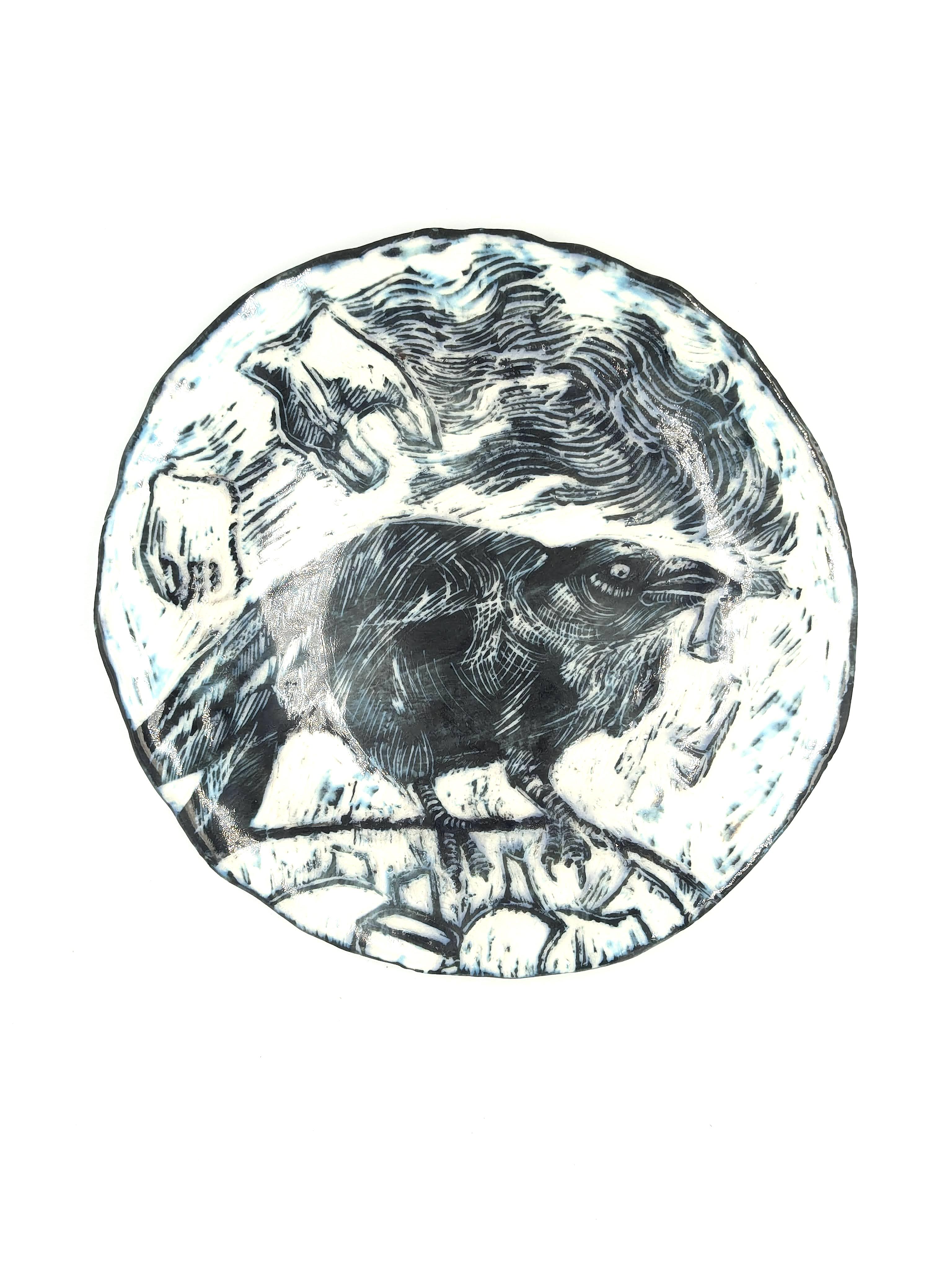 Hand built porcelain plate with black slip and sgraffito