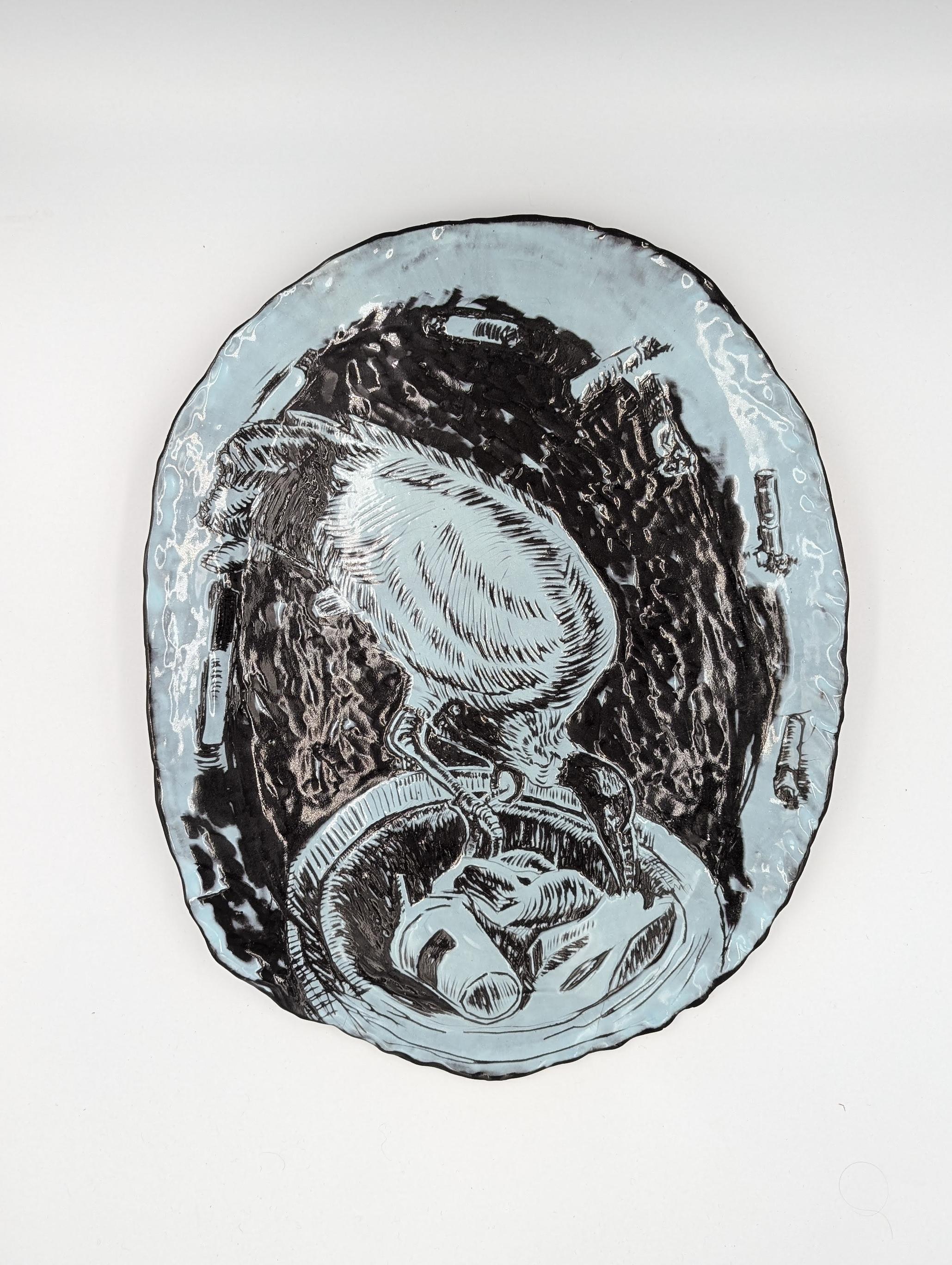 Coloured blue slip on black clay with Sgraffito.